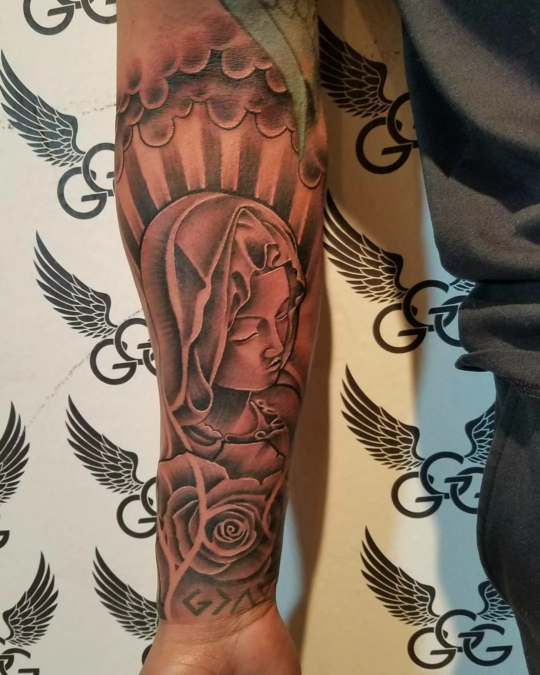 virgin mary tattoo on forearm