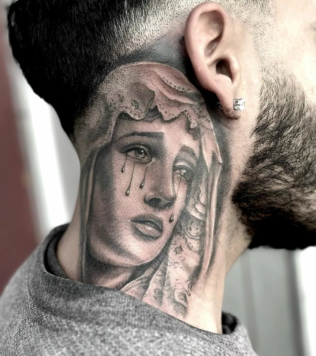 virgin mary tattoo on neck