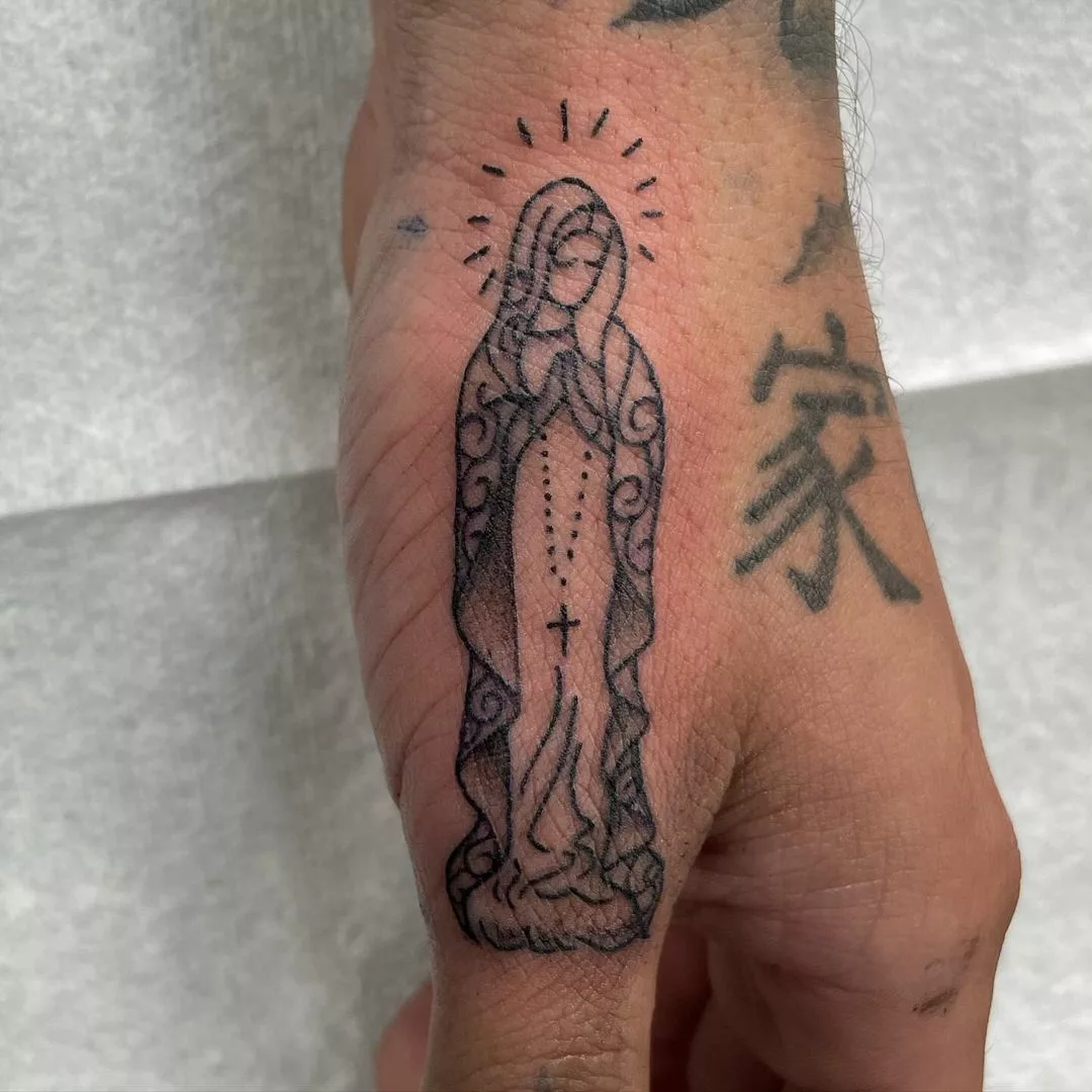virgin mary tattoo on thumb